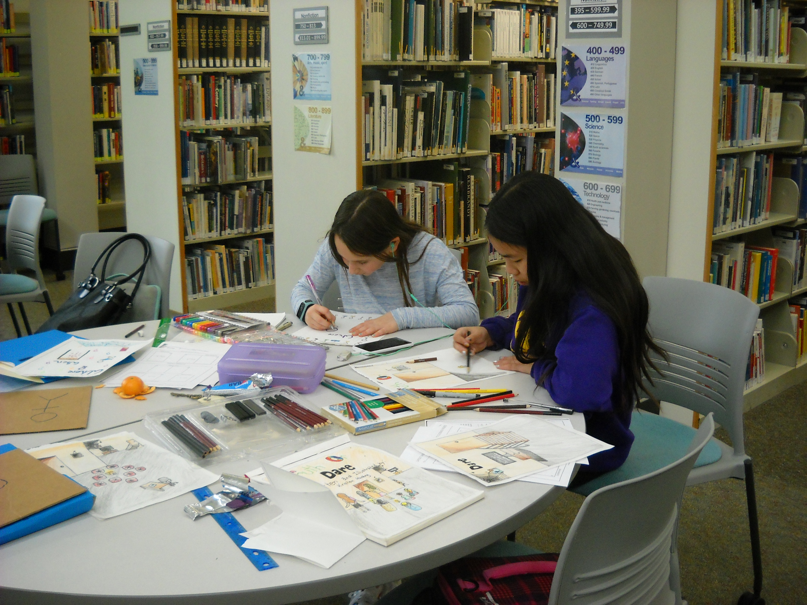 Students working on illustrations in library