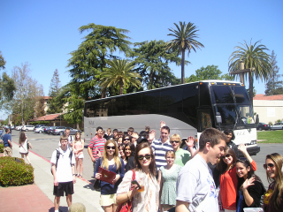 students outside tour bus