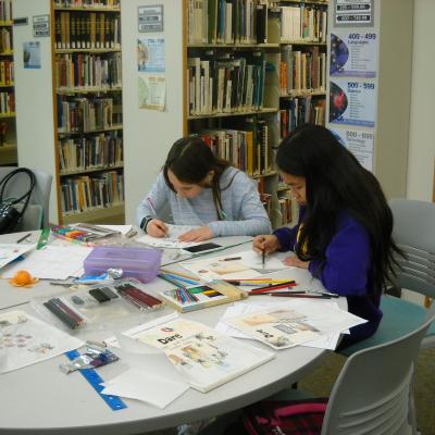 Students working on illustrations in library