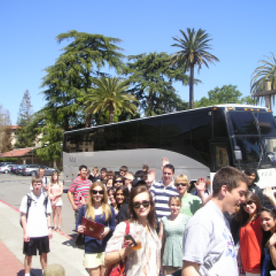 students outside tour bus