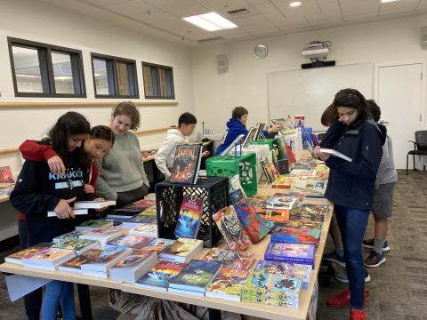 Students around books on table