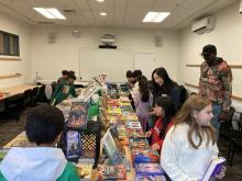 Students around books on table