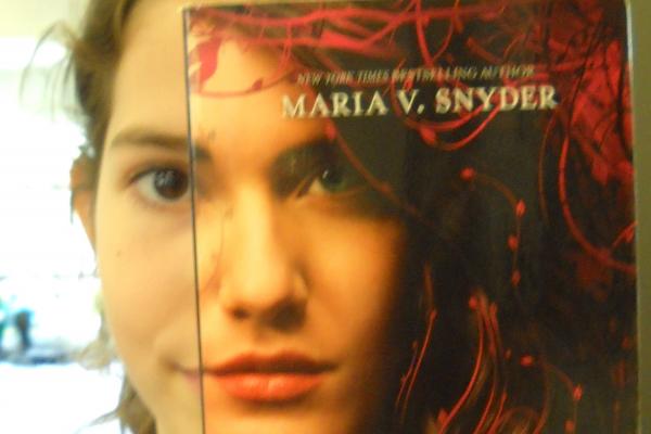 Student and book cover with face