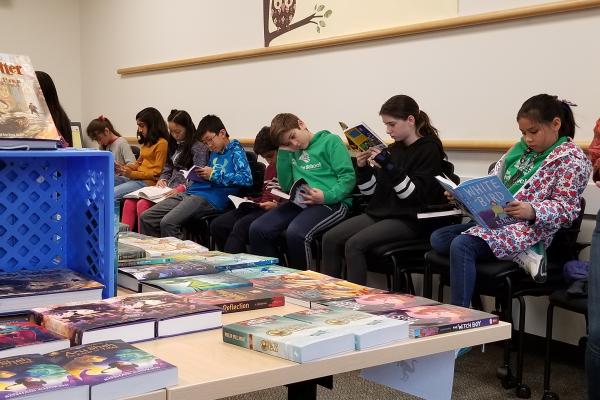 Students reading at bookfair
