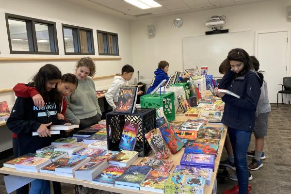 Students around books on table